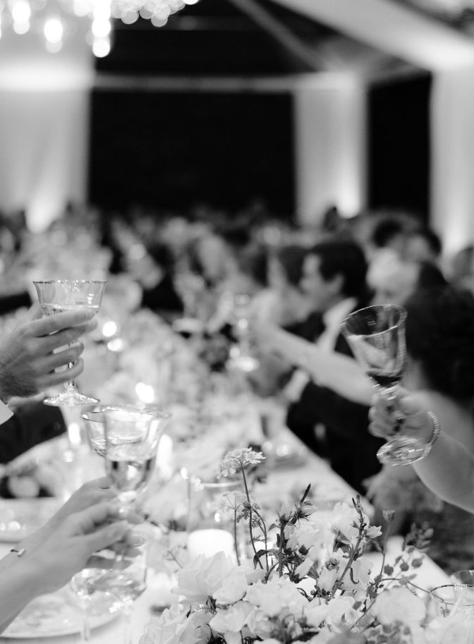 black and white photo of dinner reception toast