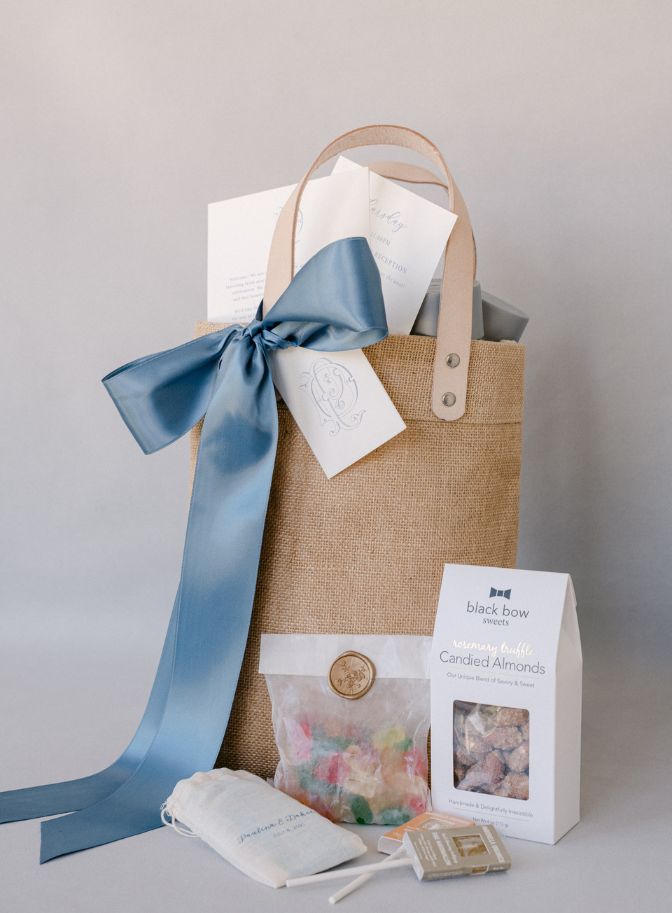 image of wedding welcome bag favor for destination wedding filled with candied almonds, gummy bears, and other treats