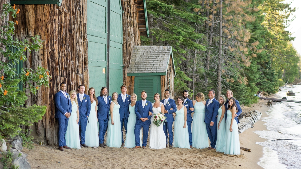 photo of bride and groom with wedding party along beach in Lake Tahoe