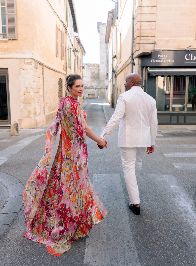 photo of couple holding hands on wedding day and walking through the streets