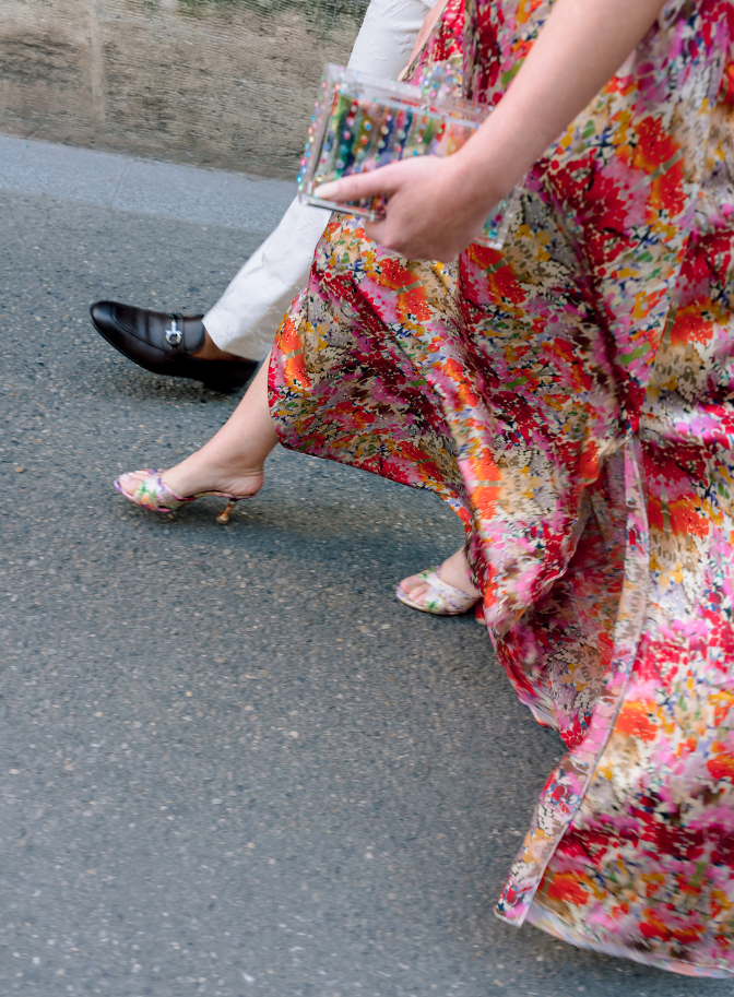 detailed shot of couples outfits as they walk hand in hand down the street on wedding day