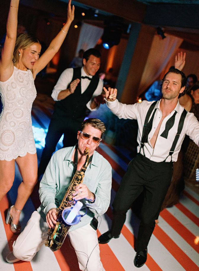 photo of bride and groom dancing with band