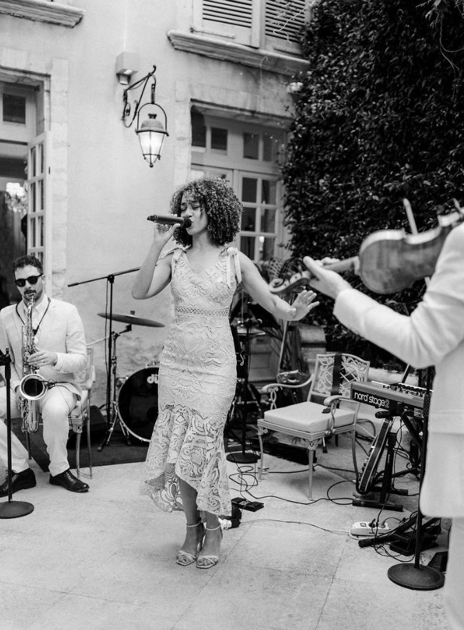 black and white photo of woman singing into a mic for a wedding