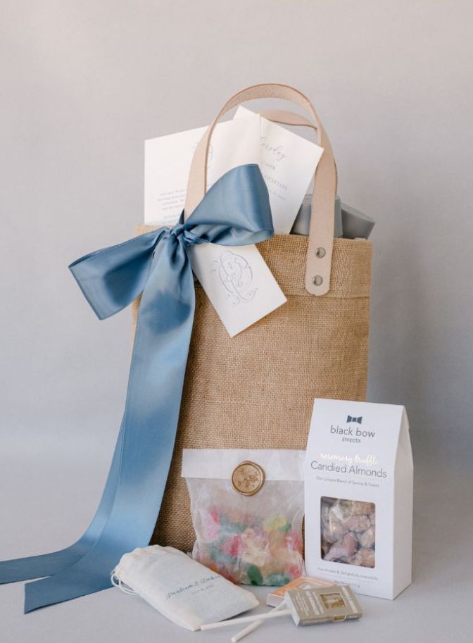 photo of wedding gift bag with a blue ribbon filled with local snacks